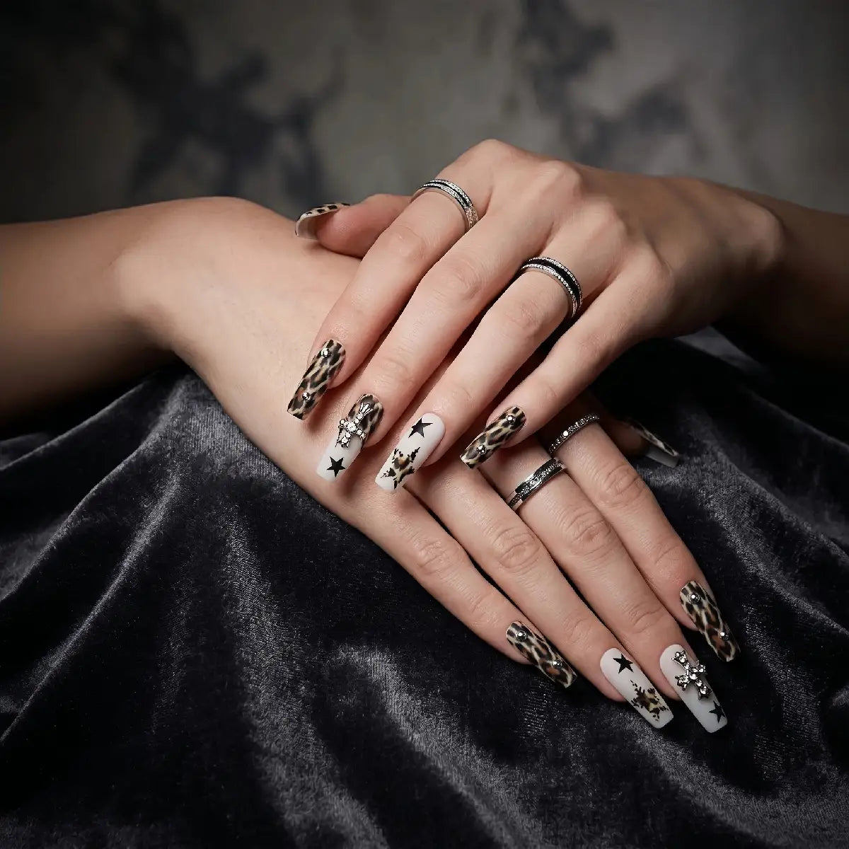 Kentrim leopard French star and cross press-on nails, 30-piece set with 15 sizes, showcasing stylish nail designs and variety. Main image