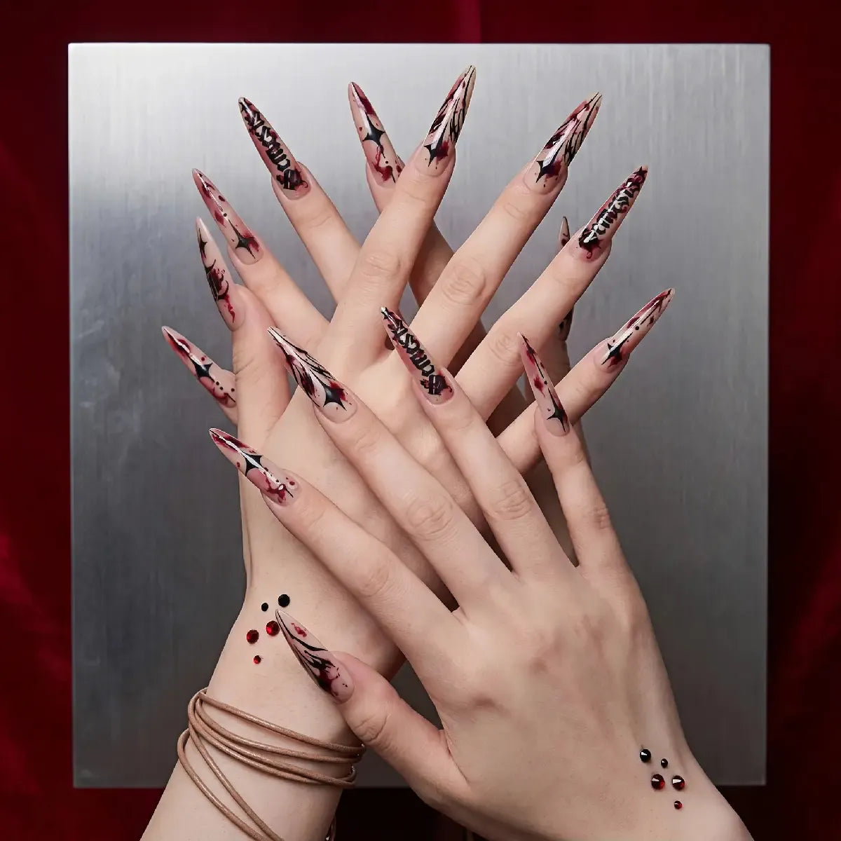 Kentrim red splatter Gothic letter press-on nails, 30-piece set with 15 sizes, showcasing the bold, artistic nail design. Main image