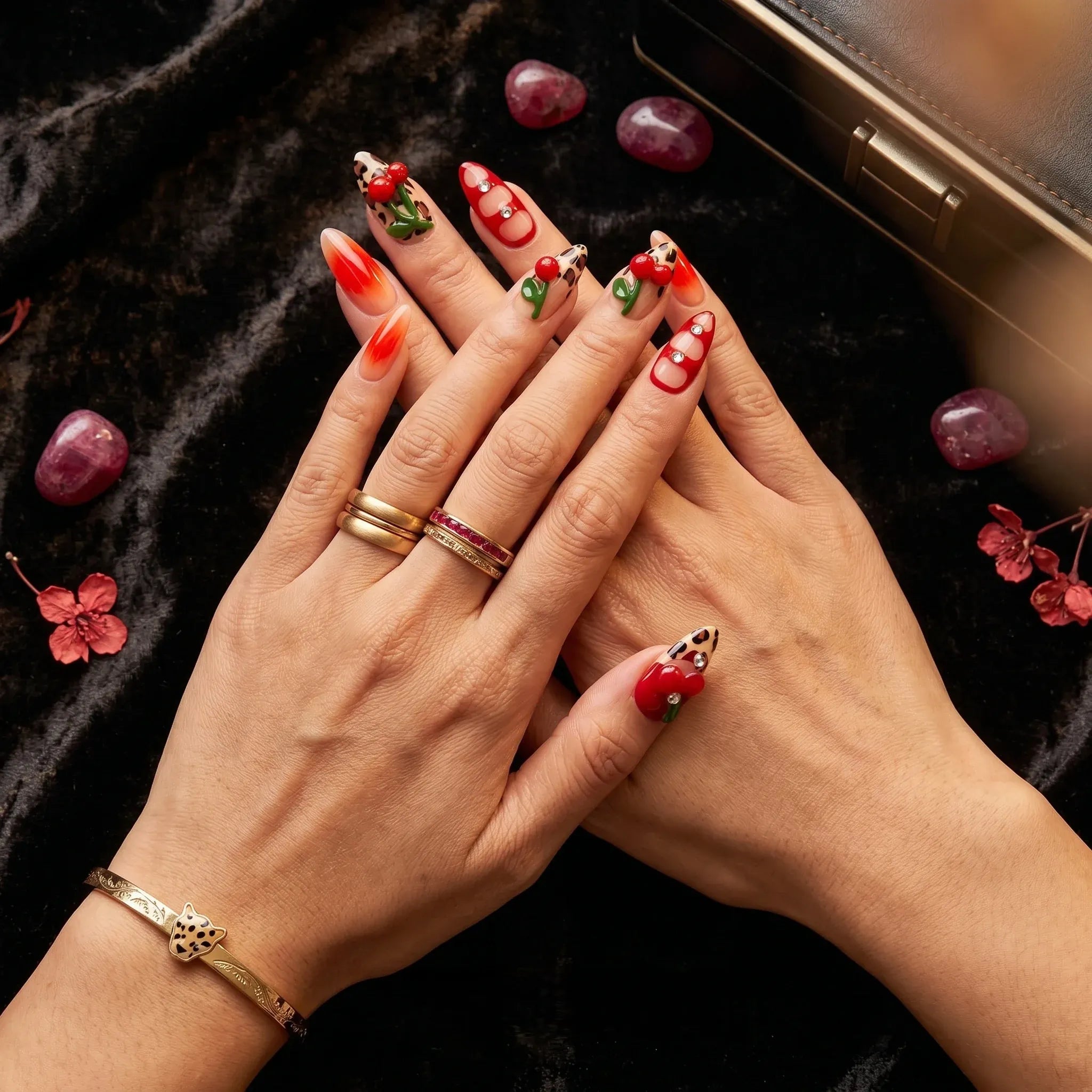 Kentrim Cherry Leopard Glam press on nails in medium almond shape with red ombre leopard print and rhinestone accents. Main image