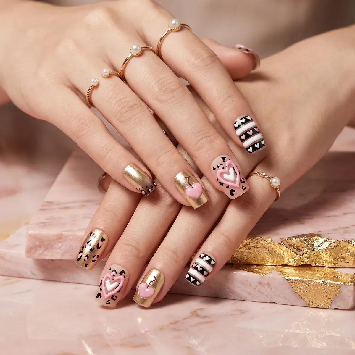 Kentrim pink leopard and gold heart cherry medium square press-on nails, 30-piece set with 15 sizes for easy nail extension. Main image