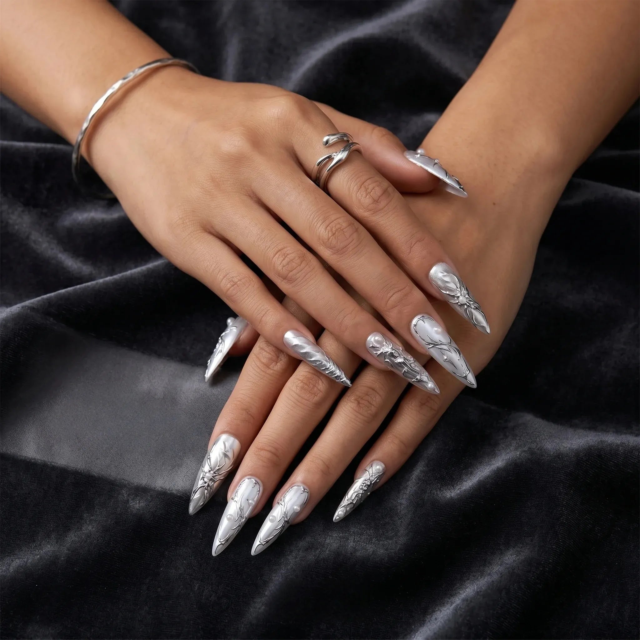 Kentrim metallic chrome floral press-on nails with 3D silver floral accents, long stiletto shape, 30 pieces in 15 sizes. Main image