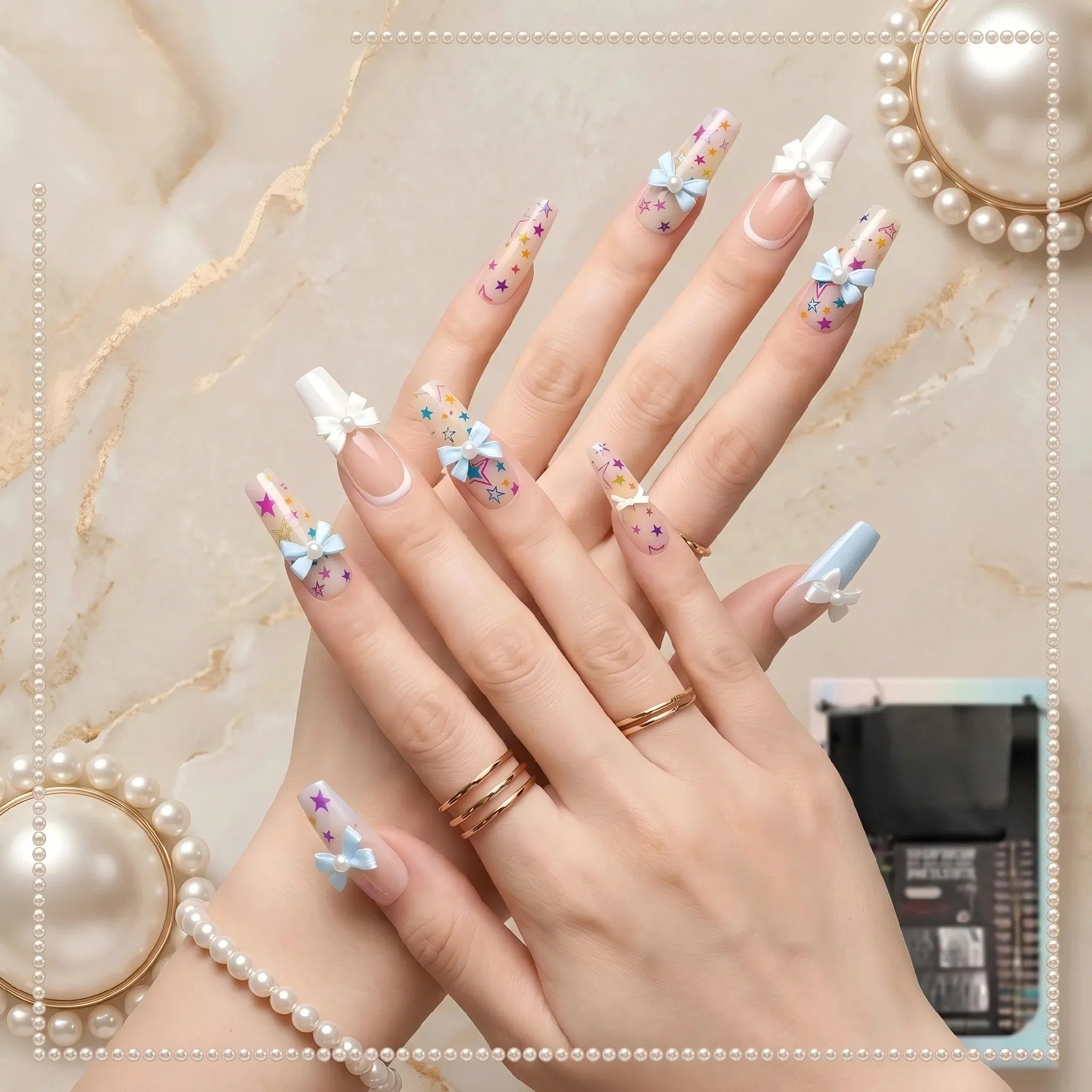 Kentrim pastel coquette bow and star press-on nails with blue and white French tips, multicolor stars, pearls, and bow accents. Main image